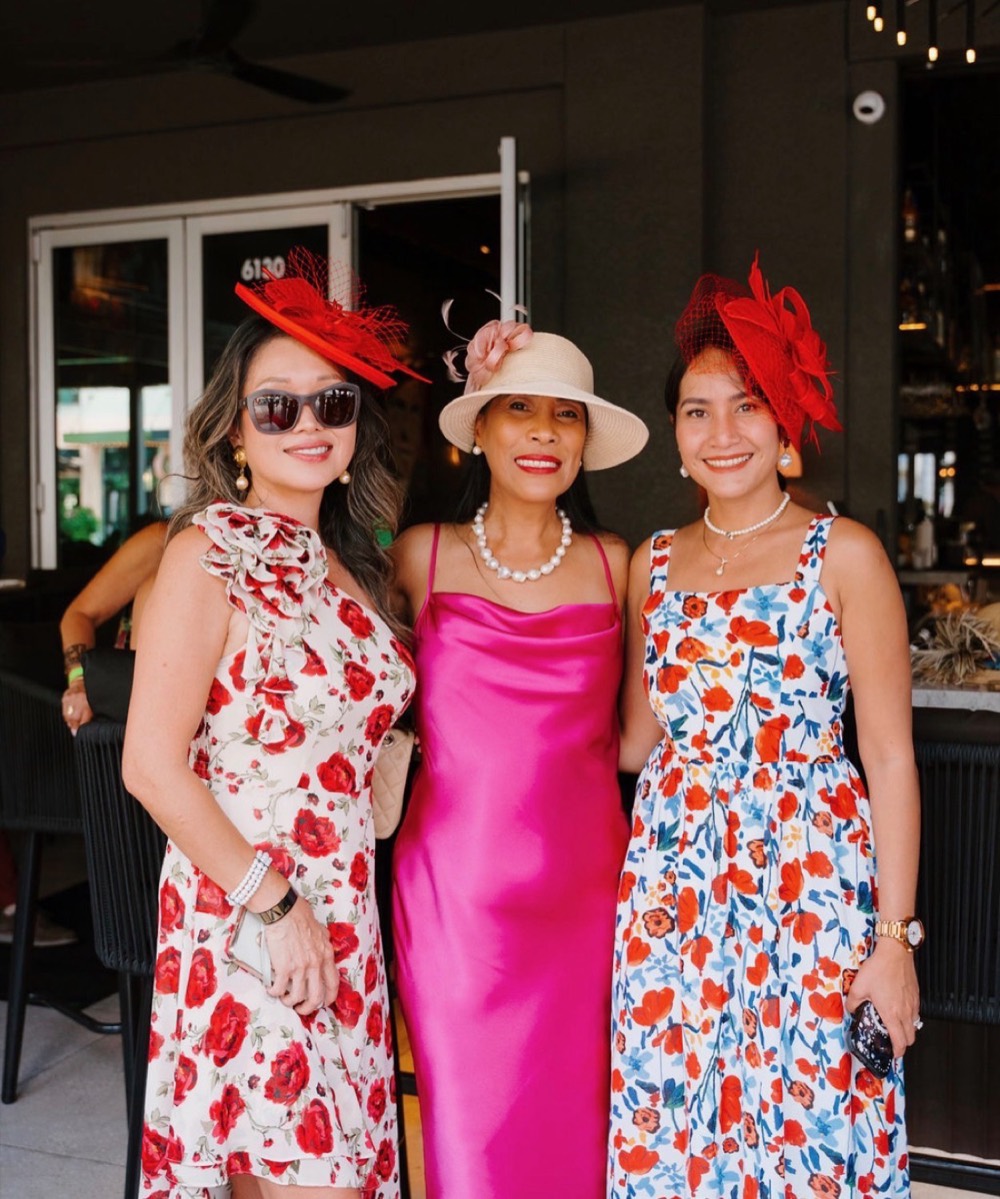 APWS members in floral dresses and hats at a spring event